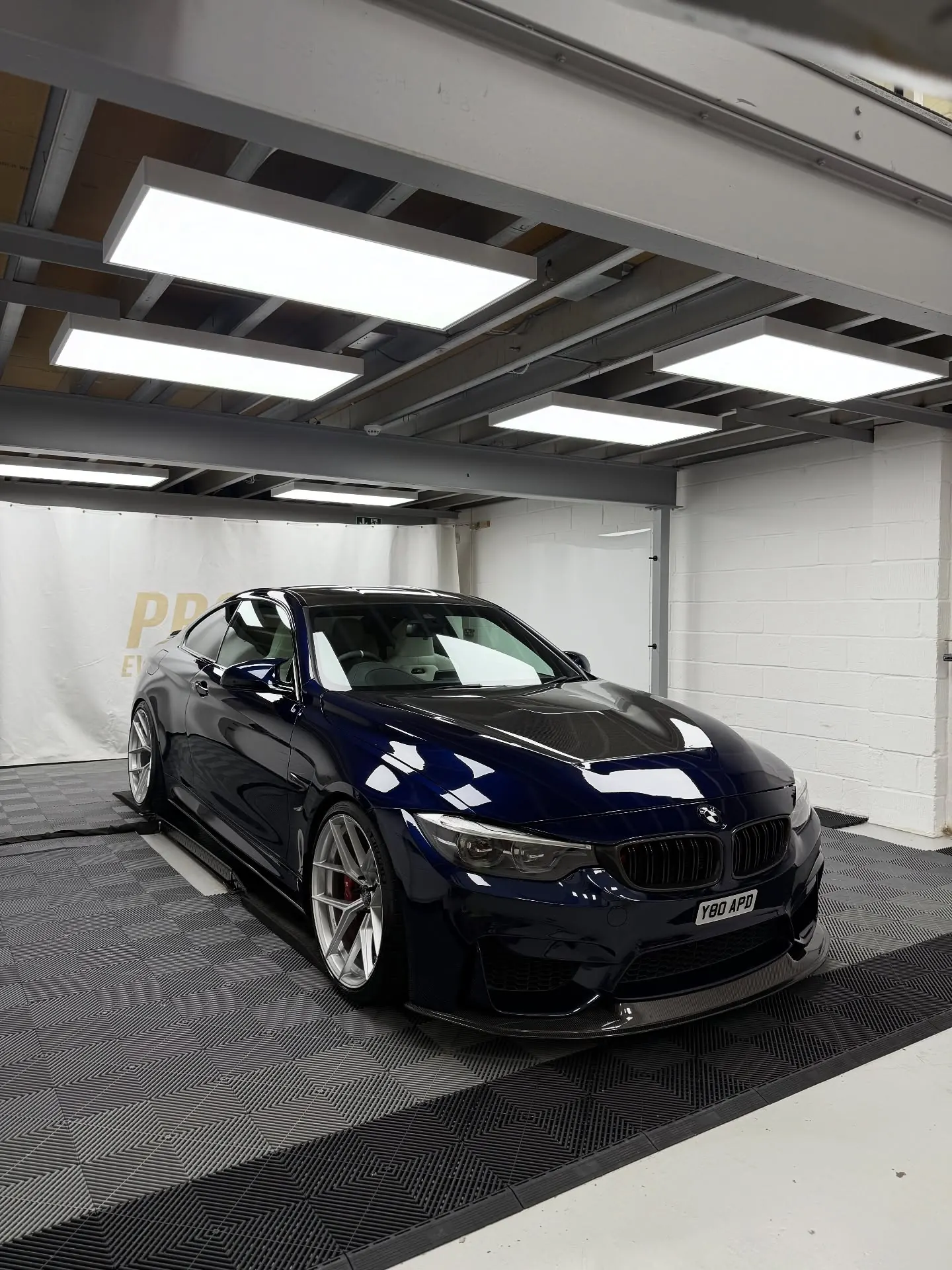 Blue BMW M4 in the Pro Evo studio wrapped in SunTek PPF