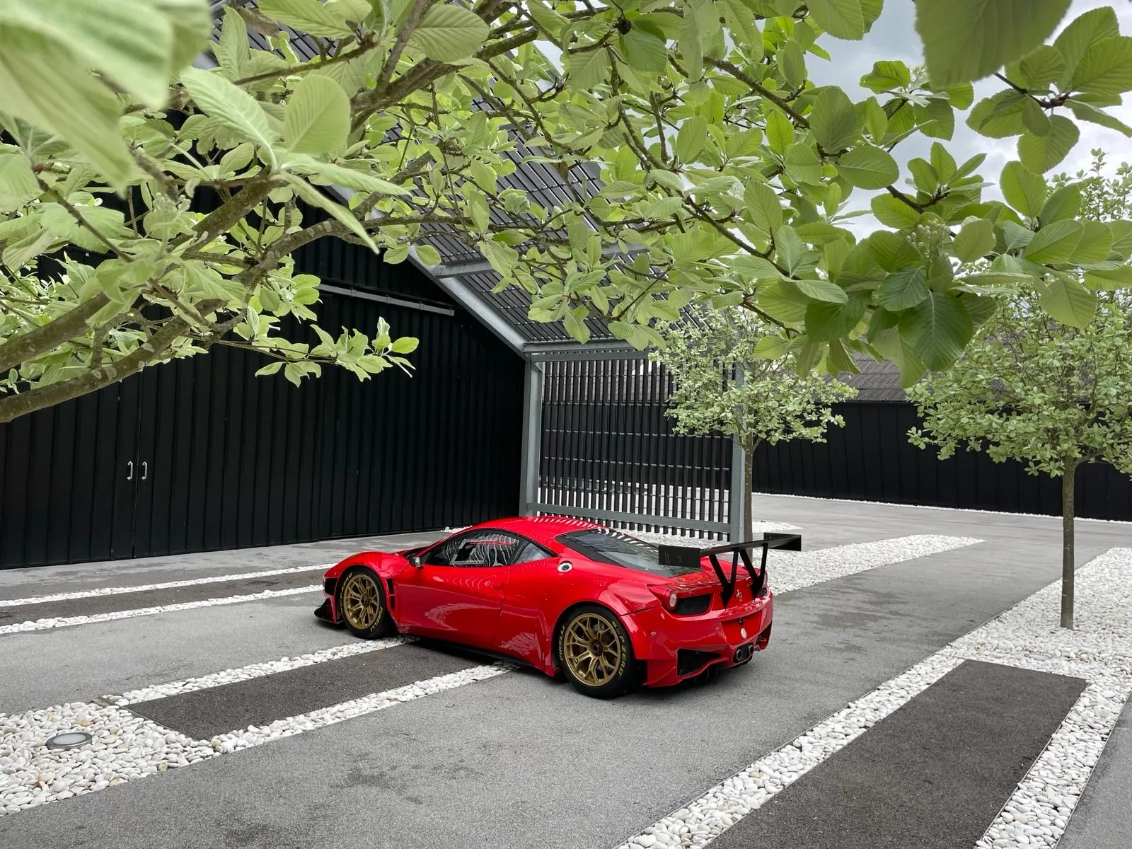 Red Ferrari 488 in a courtyard