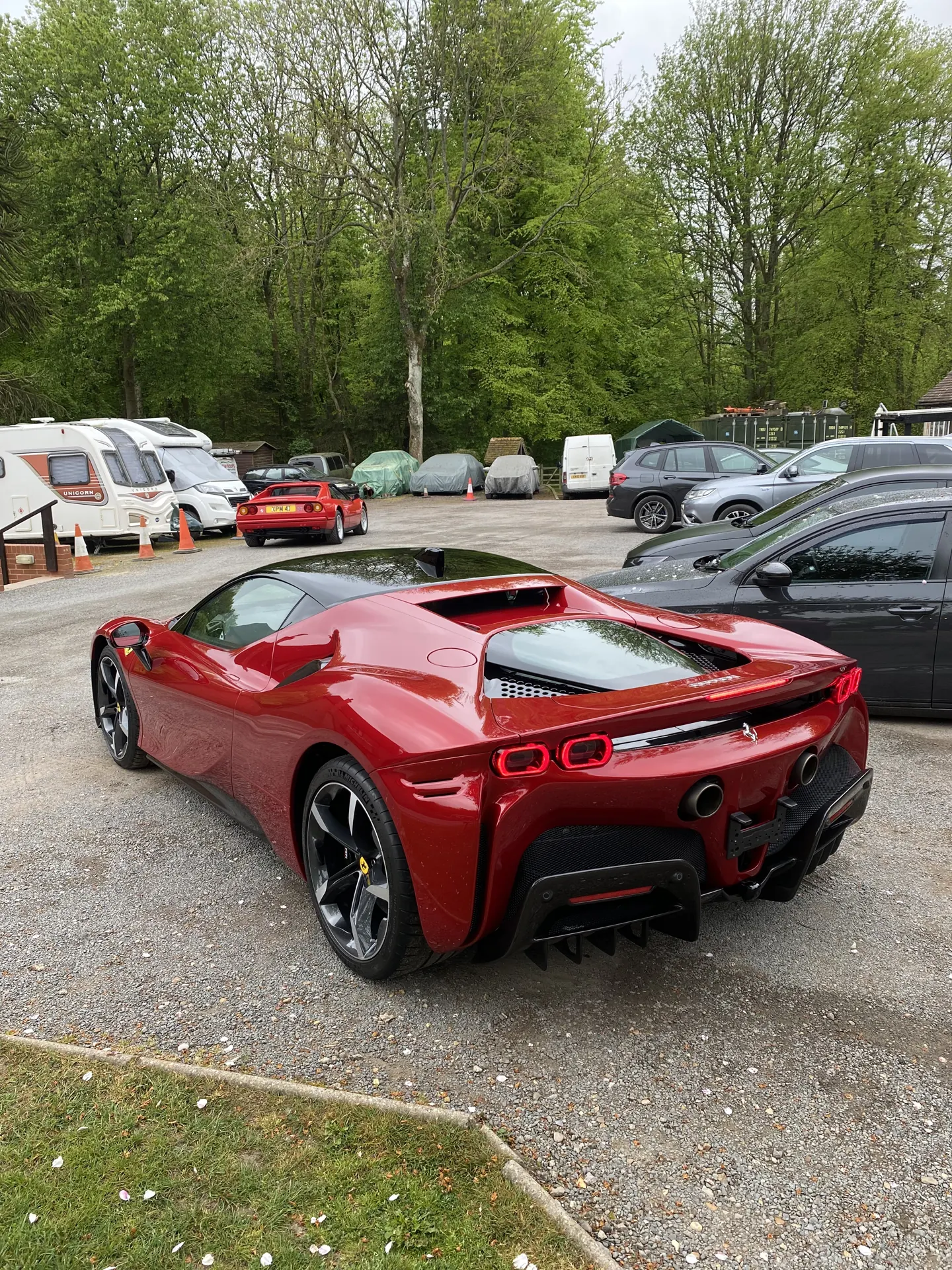 Red Ferrari SF90 rear three-quarter